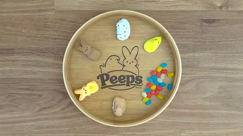 Assorted Peeps Marshmallows and jelly beans on wooden PEEPS serving tray