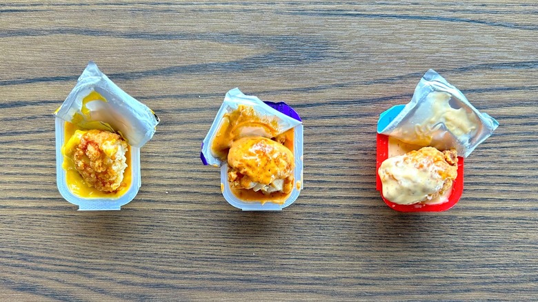 Pieces of Taco Bell Crispy Chicken Nuggets in three different dipping sauces