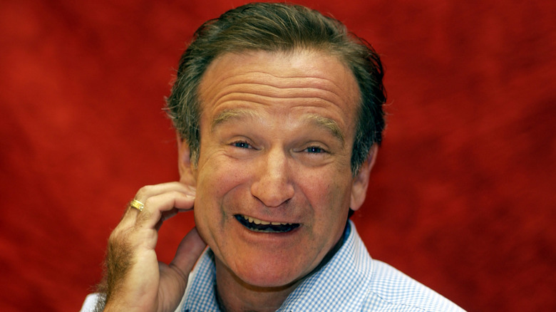 Robin Williams with a red background