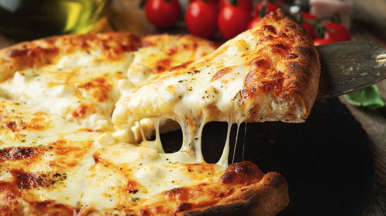 Pizza slice being pulled away from pie