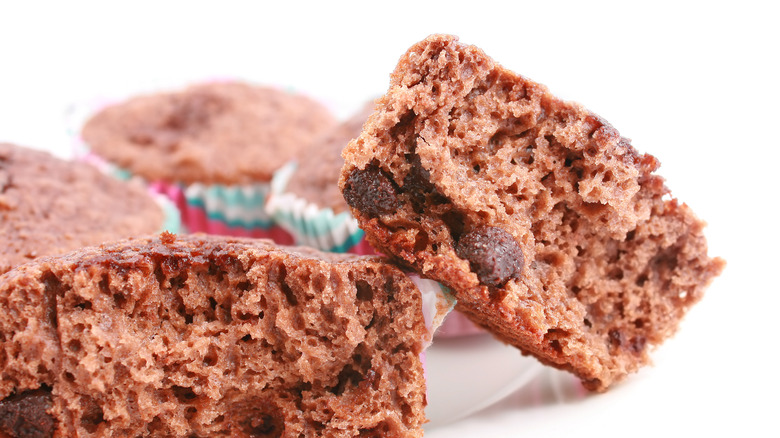 halved muffin with dense crumb muffins in background