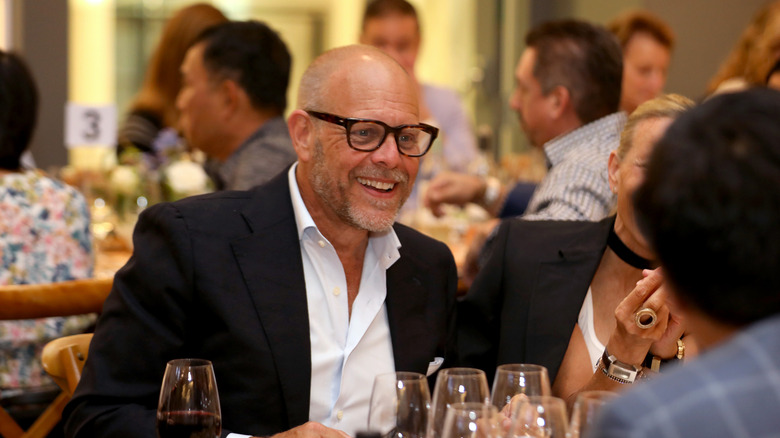 Alton Brown smiling at table