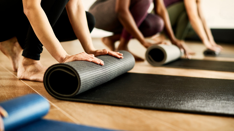 yoga mats being rolled up