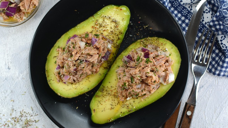 Tuna salad served on avocado halves