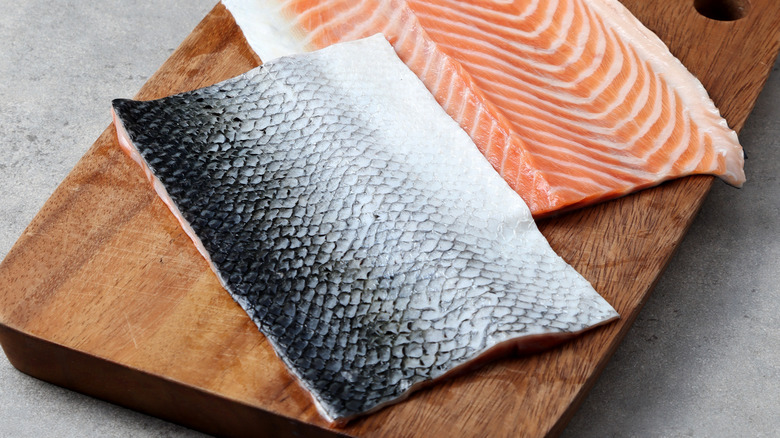 A slab of salmon skin on a cutting board 