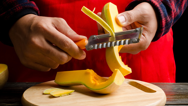Person peeling butternut squash