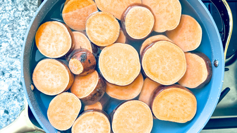 sliced sweet potatoes in water