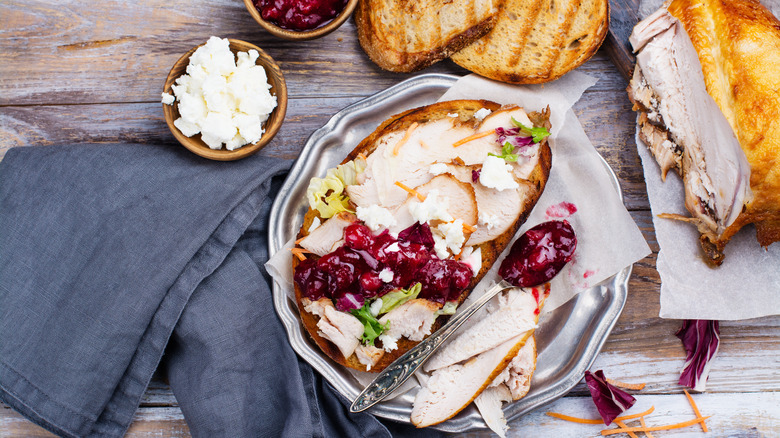 Turkey sandwich with cranberry sauce.