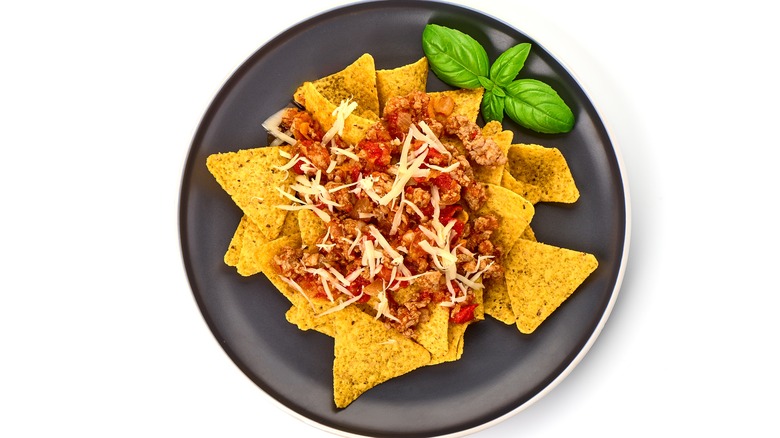 Plate of nachos with meat and cheese