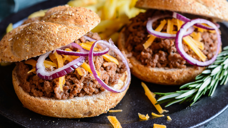 Homemade sloppy joes with red onion and shredded cheese