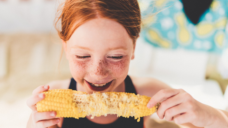girl eating corn on the cob