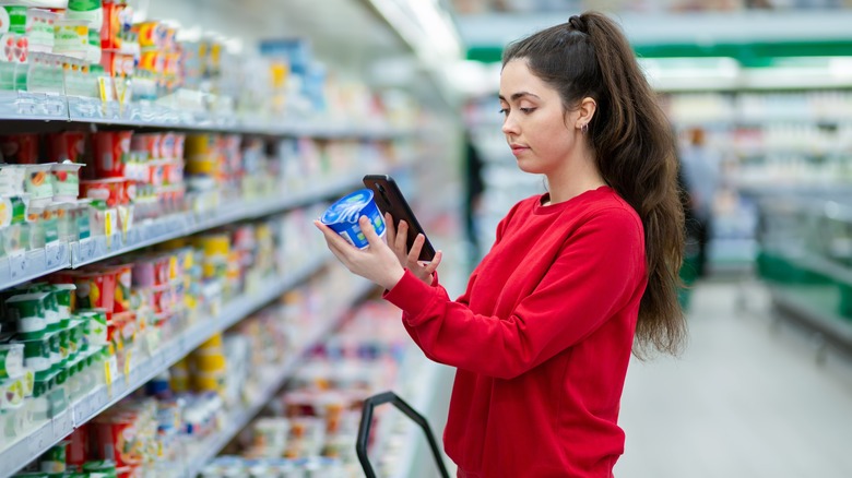 Person scanning product with mobile phone