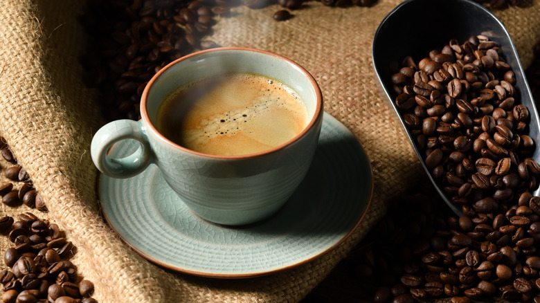 Cup of coffee with coffee beans