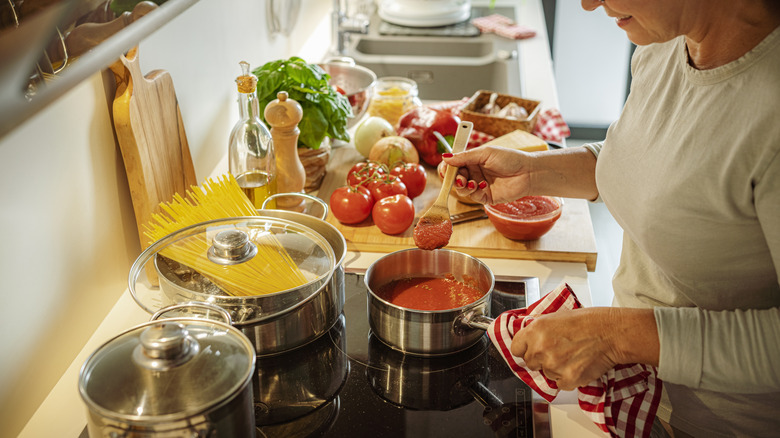 Woman making tomato sauce