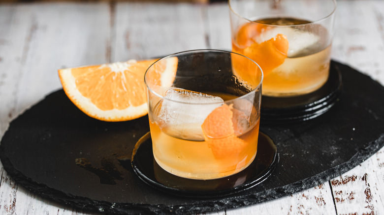 two cocktail glasses with orange