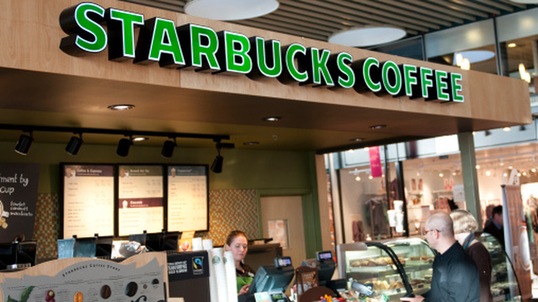 Interior shot of a Starbucks counter with a person ordering