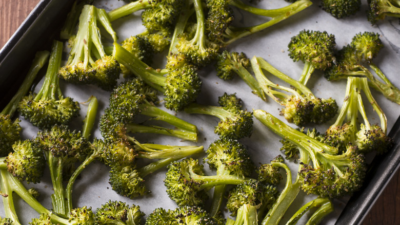 Charred broccoli on baking pan