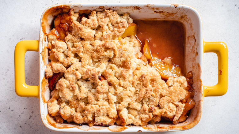 Juicy peach cobbler in yellow dish