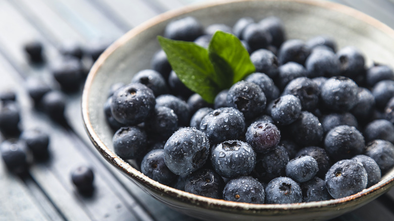 Freshly washed blueberries in a ceramic bowl