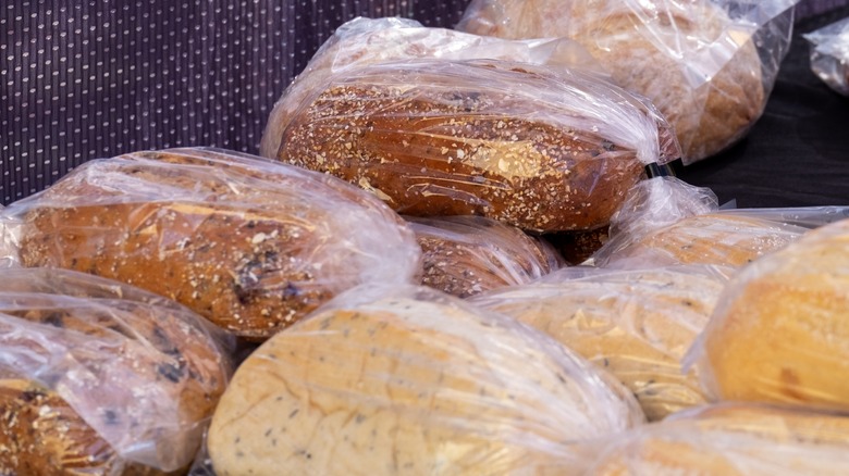 Loaves of different types of bread wrapped in plastic