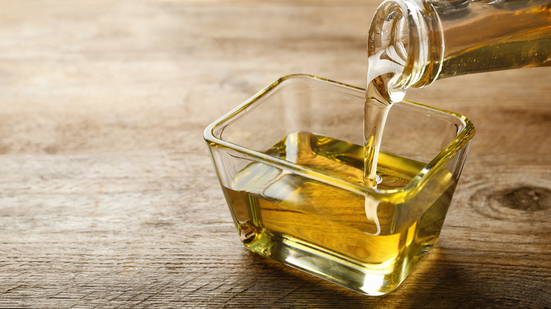 Pouring cooking oil into a bowl
