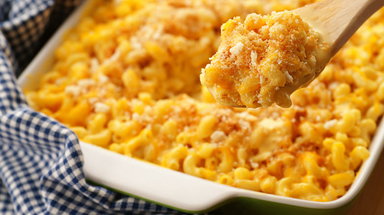 Mac and cheese on spoon and in baking dish