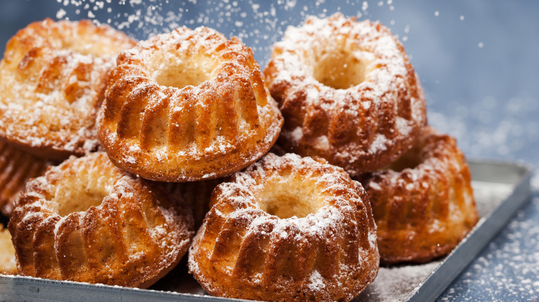 Mini bundt cakes dusted with powdered sugar on a gray background