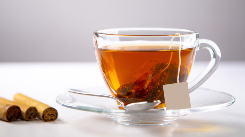 cup of tea near cinnamon sticks