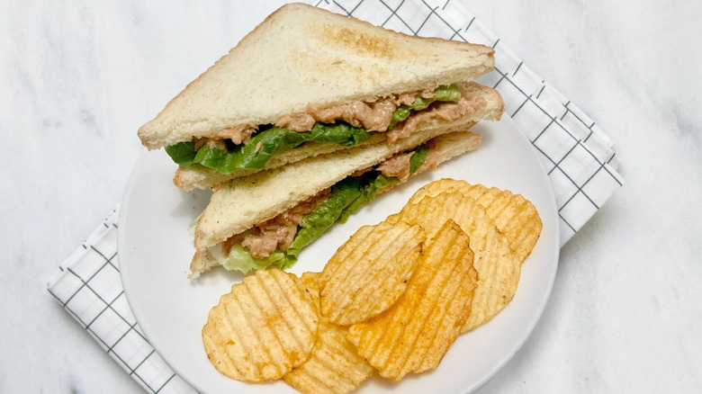 Tuna salad sandwich with lettuce and potato chips