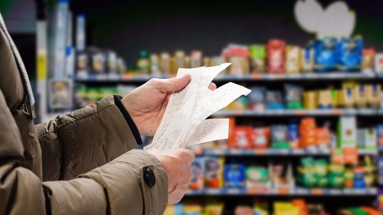 Holding receipt at grocery store