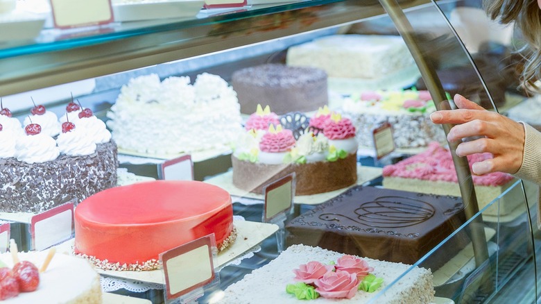 Hand pointing at cakes