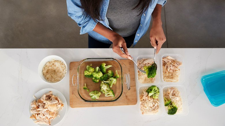 Woman packaging meals in containers