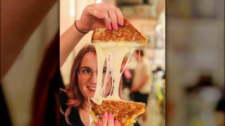 Woman holding up grilled cheese