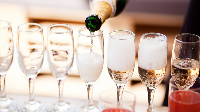pouring prosecco into flutes