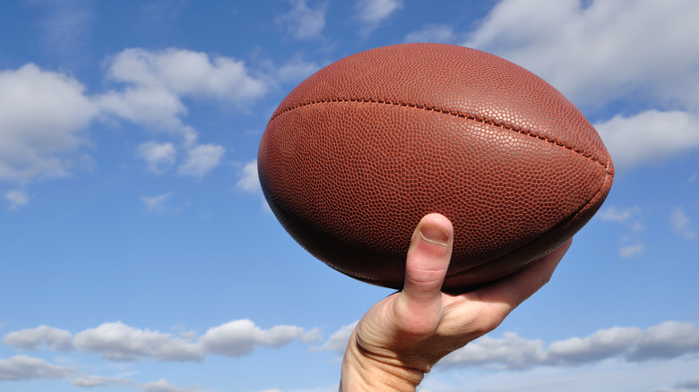 Hands throwing a football