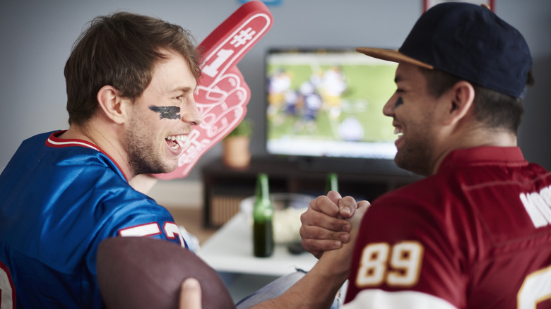 Friends cheering on football game