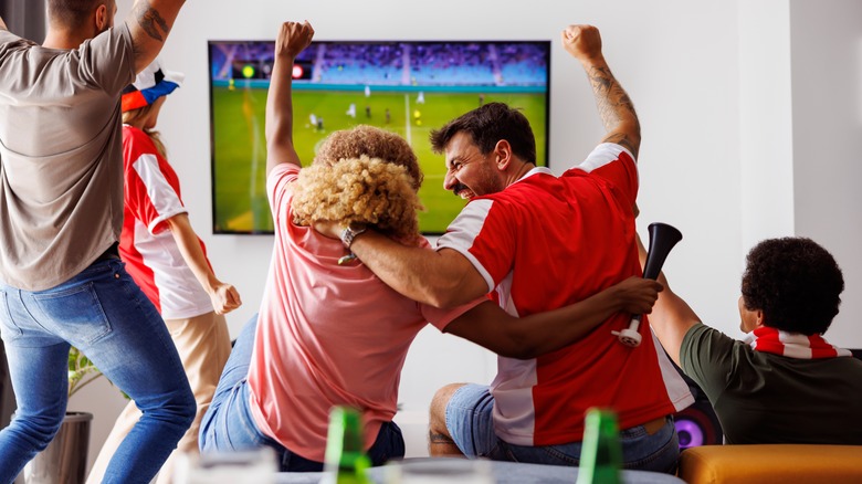 Friends partying watching football