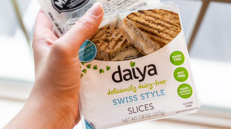 Hand holding Daiya vegan cheese
