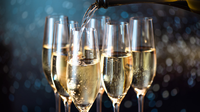 pouring champagne into flutes