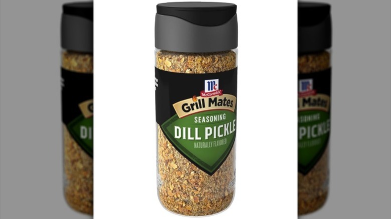 Isolated on a white background is a container of McCormick Grill Mates Dill Pickle Seasoning