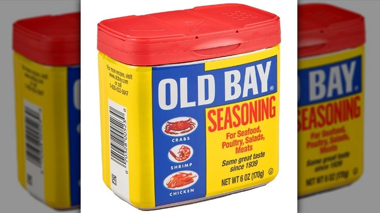 Isolated on a white background is a container of Old Bay Seasoning