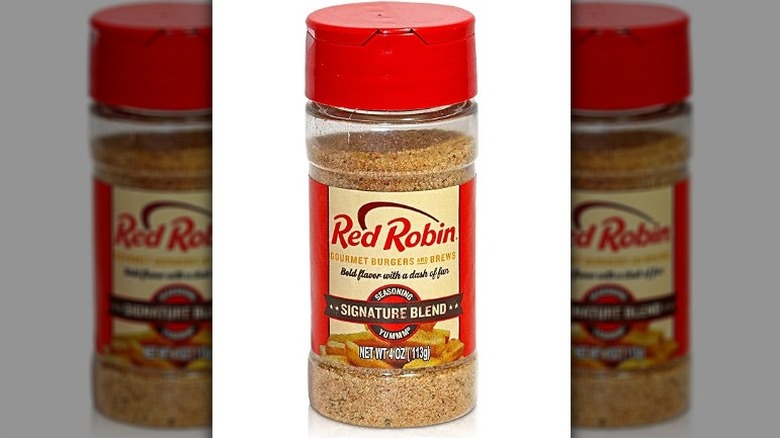 Isolated on a white background is a container of Red Robin Original Blend Signature Seasoning