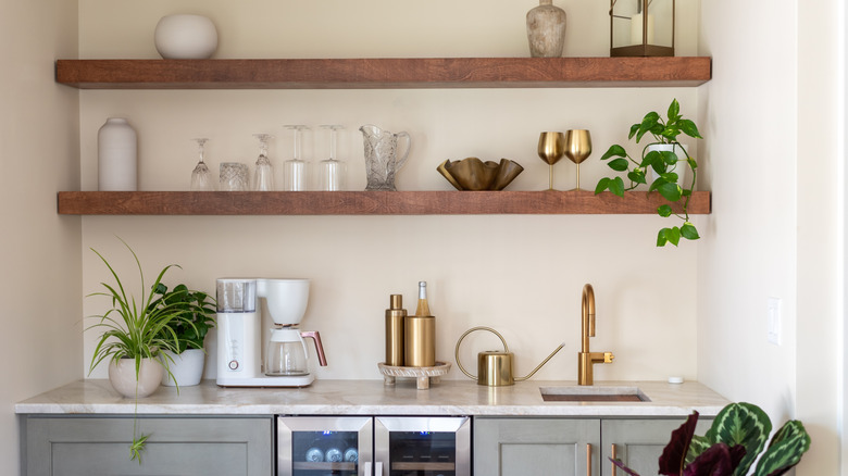 Floating shelves in a kitchen above a small sink