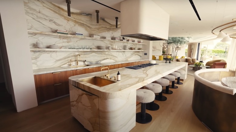 John Legend and Chrissy Teigen's kitchen, with a marble wall and kitchen island