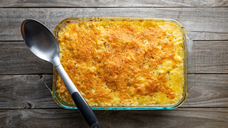 Rice casserole in a dish, topped with crispy baked cheese
