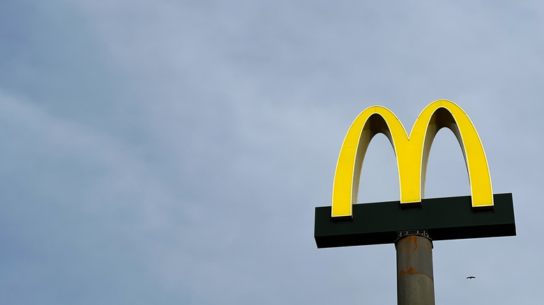 McDonald's arches surrounded by grey clouds