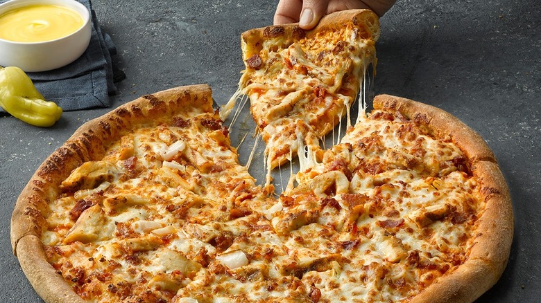 Buffalo chicken pizza slice being pulled