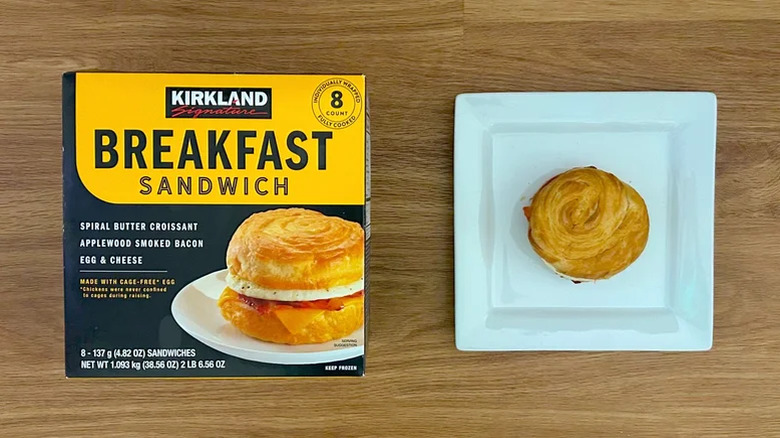 Package and white square plate of Kirkland Signature Breakfast Sandwich