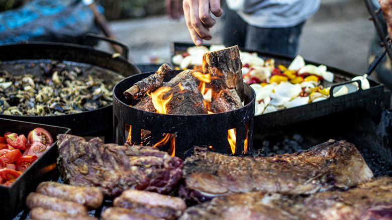 A grill full of steak and vegetables