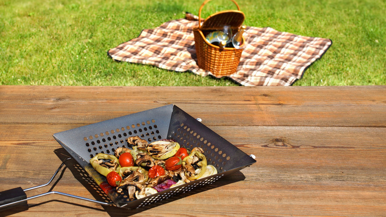 A grill basket full of vegetables